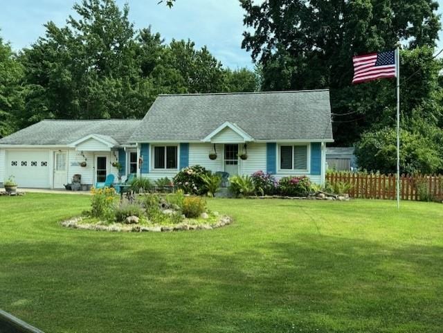 single story home with fence, an attached garage, and a front lawn