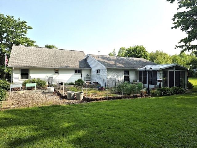 1233 Gunton Dr, Fairview, PA 16415 - back of house featuring a vegetable garden, a sunroom, a lawn, and a shingled roof