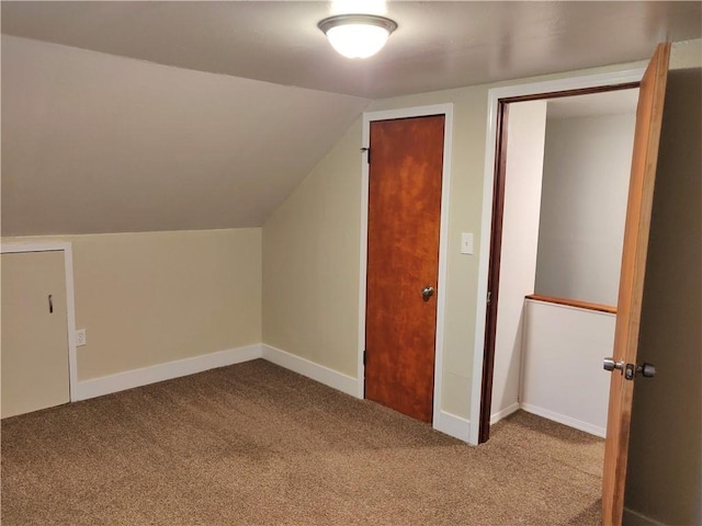 additional living space featuring carpet, lofted ceiling, and baseboards