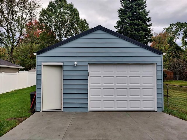 detached garage featuring fence