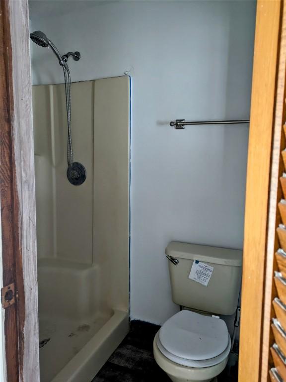 bathroom featuring toilet and walk in shower