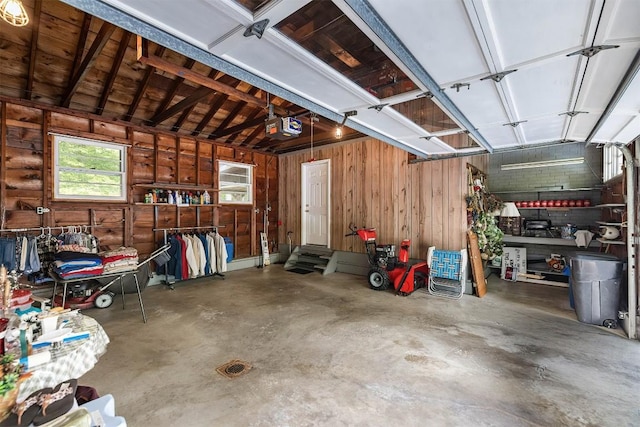 garage featuring wooden walls and a garage door opener