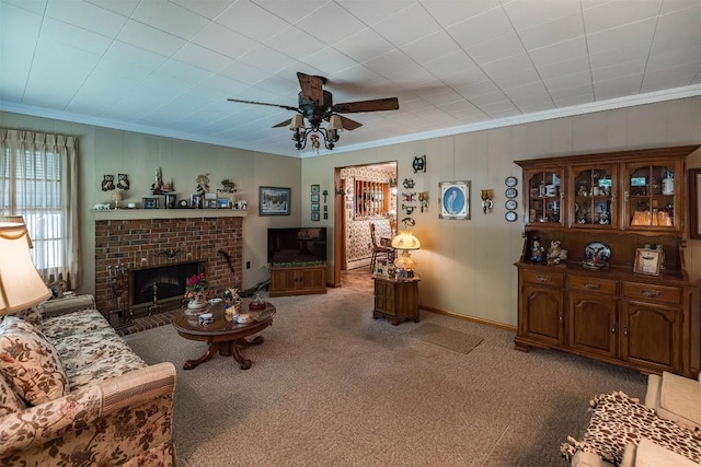 carpeted living room featuring a brick fireplace, ceiling fan, and ornamental molding