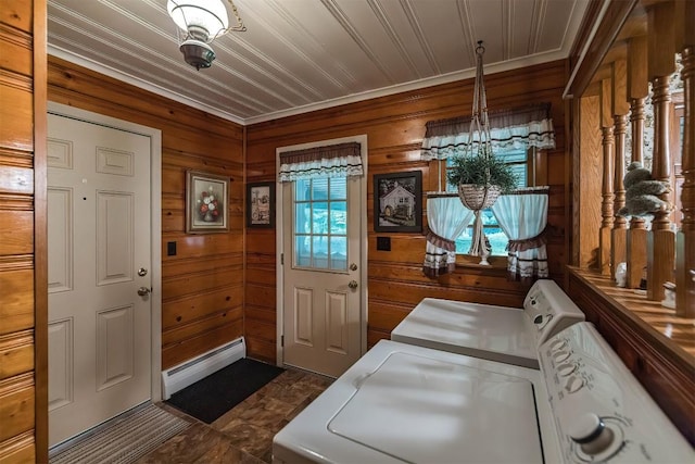 laundry room featuring wood walls, washer and clothes dryer, and ornamental molding