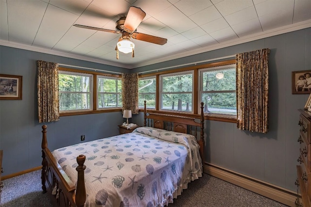 carpeted bedroom featuring ceiling fan, crown molding, multiple windows, and a baseboard radiator