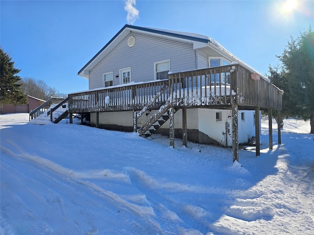 snow covered property featuring a deck