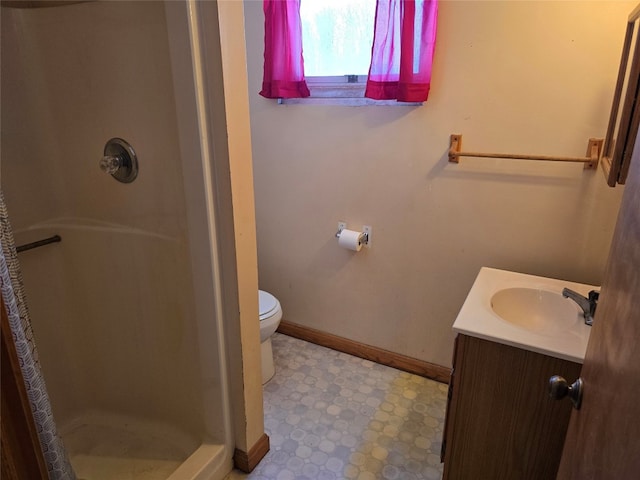 bathroom with toilet, walk in shower, and vanity