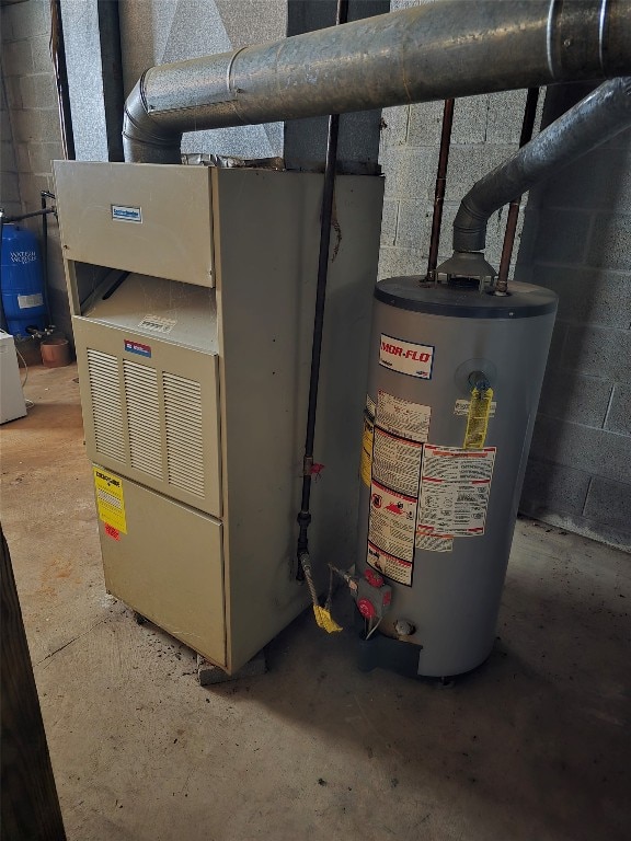 utility room with heating unit and water heater