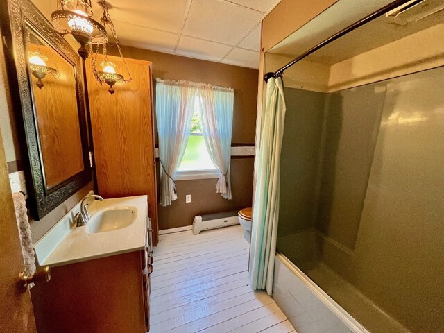 1003 Filmore Ave, Erie, PA 16505 - bathroom featuring vanity, baseboard heating, shower / bath combo, and wood finished floors