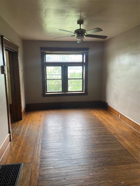 spare room featuring hardwood / wood-style floors and ceiling fan