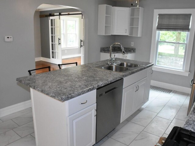 221 Locust St, Meadville, PA 16335 - kitchen featuring stainless steel dishwasher, arched walkways, light marble finish floors, open shelves, and white cabinetry