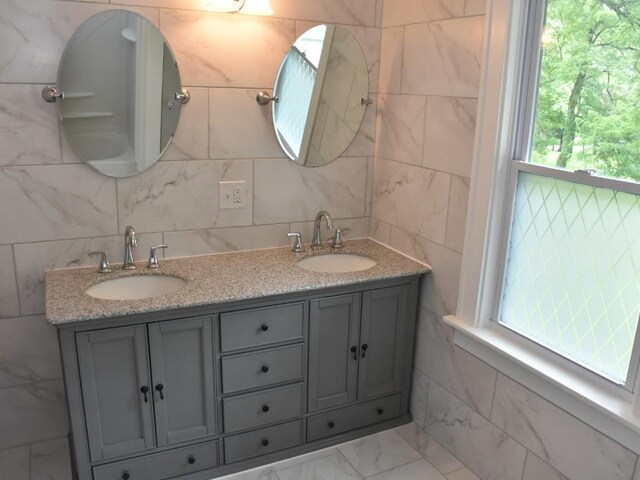 221 Locust St, Meadville, PA 16335 - bathroom with plenty of natural light, double vanity, tasteful backsplash, and tile walls