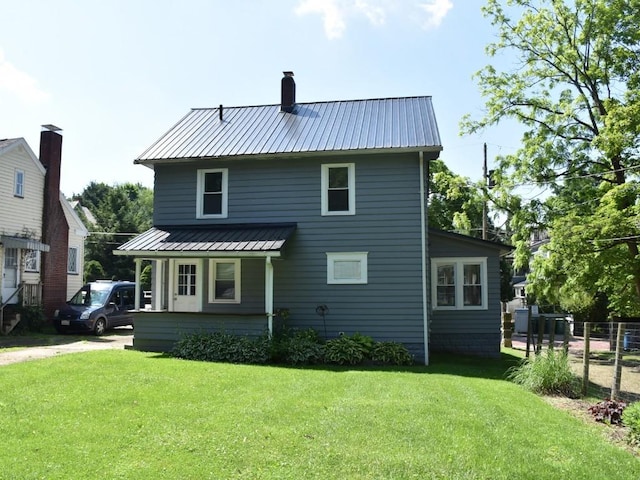 221 Locust St, Meadville, PA 16335 - back of property with a metal roof and a chimney
