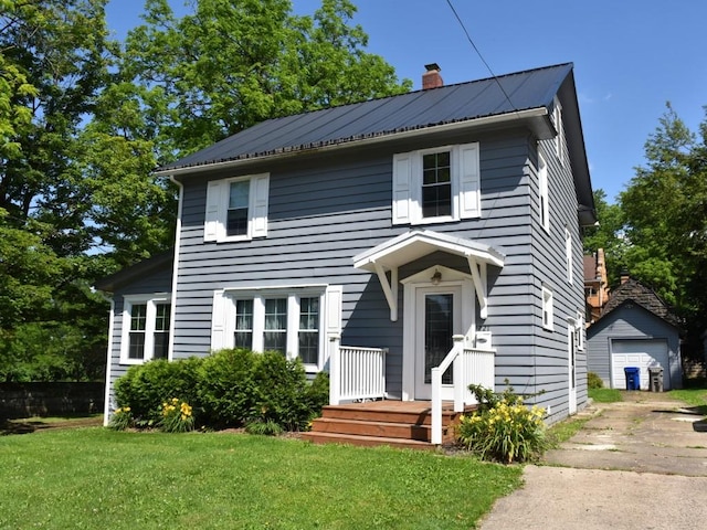221 Locust St, Meadville, PA 16335 - traditional style home with concrete driveway, a chimney, an outdoor structure, a detached garage, and a front yard
