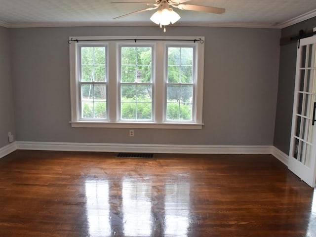 221 Locust St, Meadville, PA 16335 - spare room with ceiling fan, a barn door, crown molding, and wood finished floors
