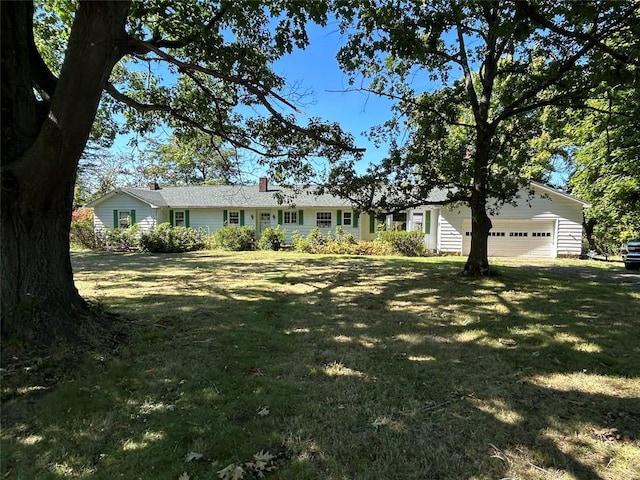 ranch-style house with a garage and a front lawn