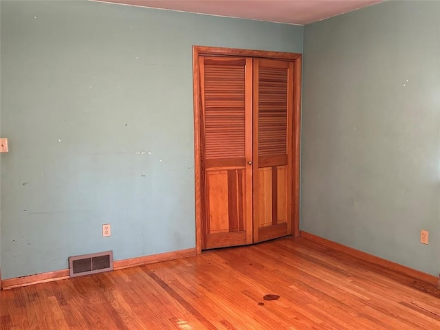 unfurnished bedroom with light wood-type flooring