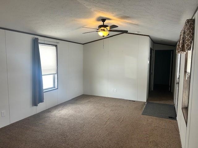 unfurnished room with lofted ceiling, ceiling fan, a textured ceiling, and carpet