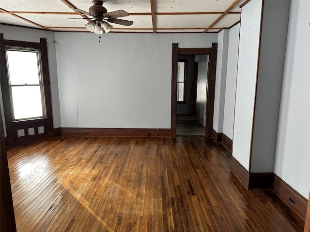 empty room featuring ceiling fan and dark wood-type flooring