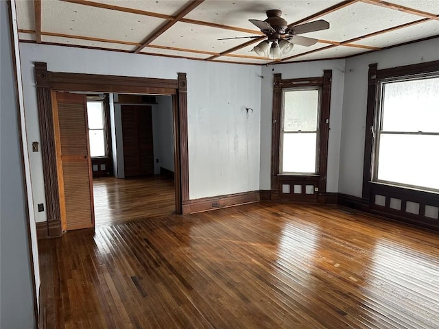 spare room featuring ceiling fan and dark wood-type flooring