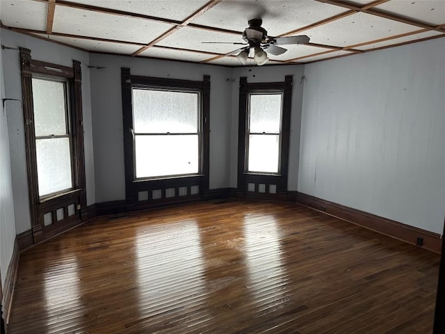 empty room with ceiling fan and dark hardwood / wood-style floors