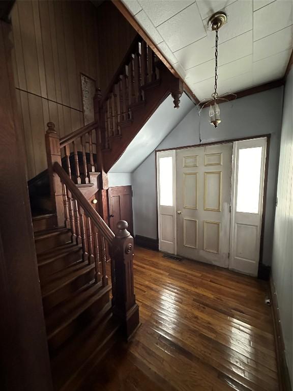 entryway with dark hardwood / wood-style floors, plenty of natural light, and lofted ceiling