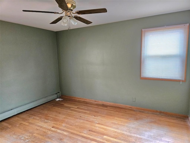 empty room featuring light wood-style floors, a ceiling fan, baseboards, and baseboard heating