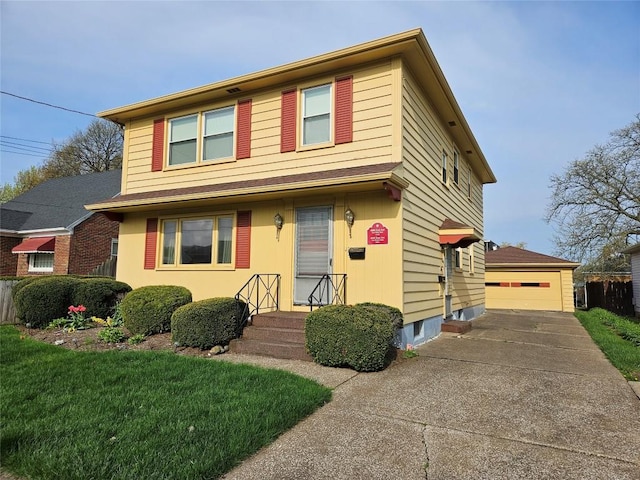 traditional-style home with a detached garage, an outbuilding, and a front yard