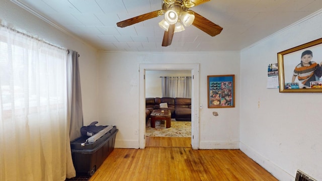 hallway featuring wood-type flooring and ornamental molding