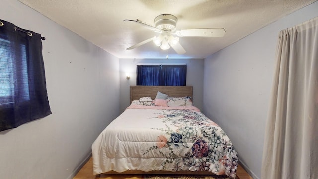 bedroom with wood-type flooring and ceiling fan