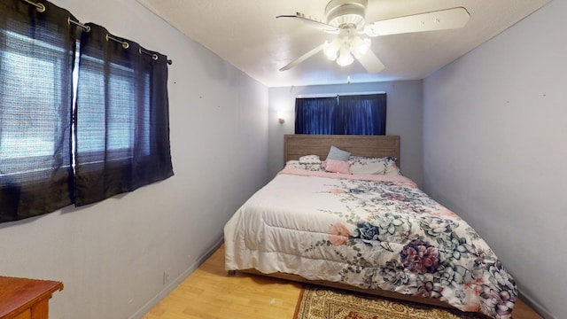 bedroom featuring hardwood / wood-style flooring and ceiling fan