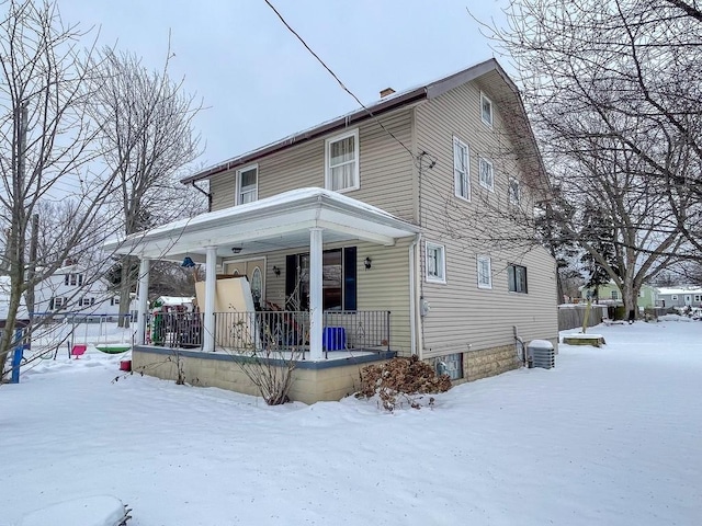 view of snow covered rear of property