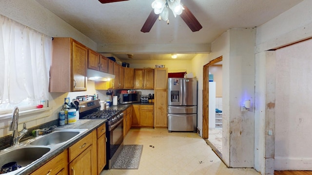 kitchen featuring ceiling fan, sink, and appliances with stainless steel finishes