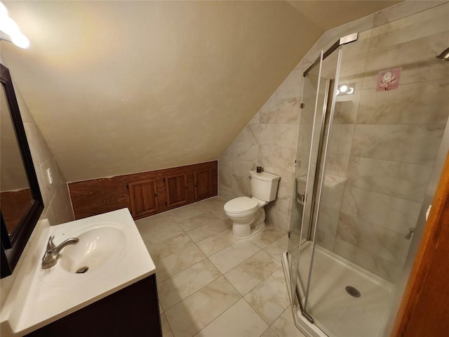 bathroom with walk in shower, tile patterned floors, vaulted ceiling, toilet, and vanity