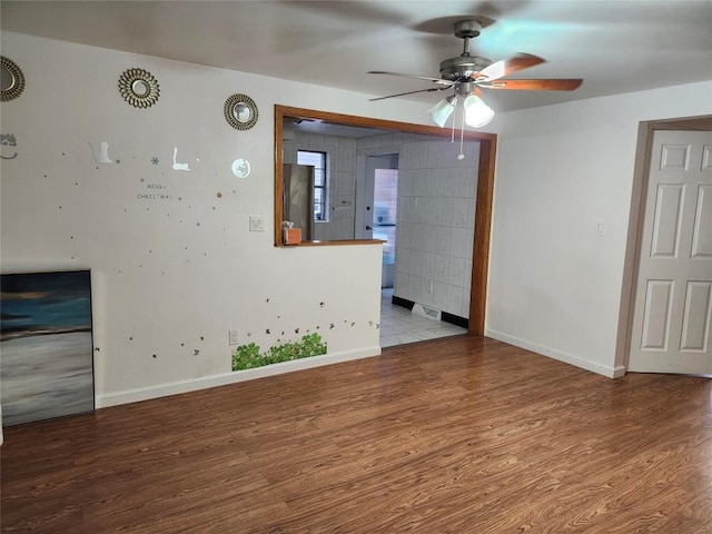 spare room with hardwood / wood-style floors and ceiling fan