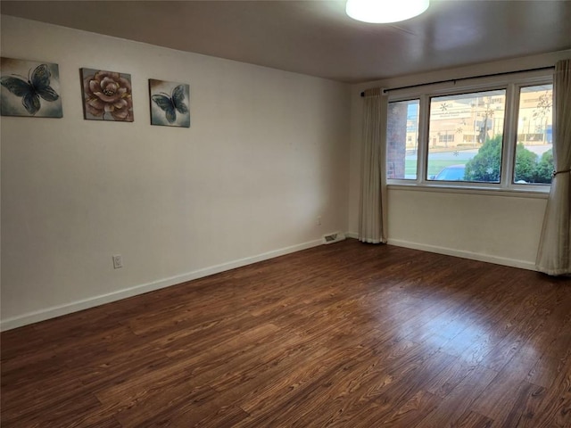 unfurnished room featuring dark wood-type flooring