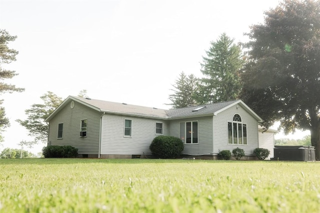 rear view of house featuring a lawn