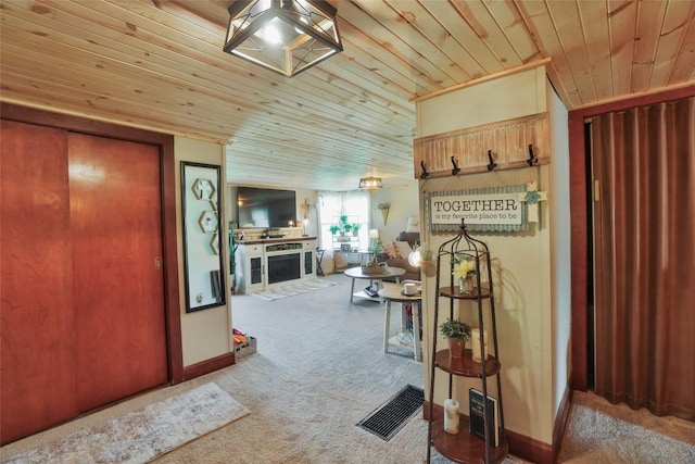 interior space featuring carpet flooring and wood ceiling