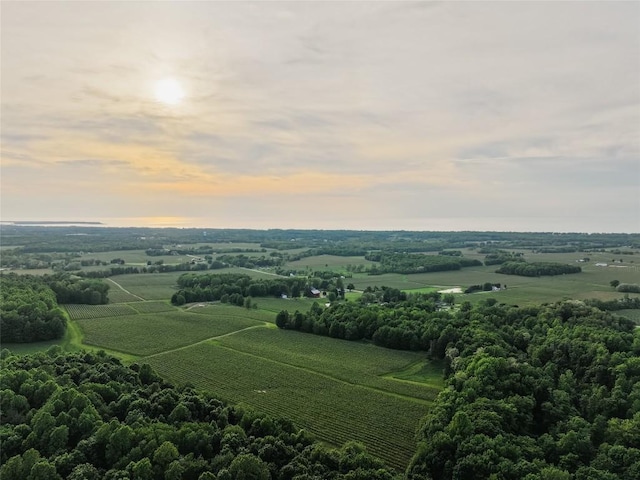 aerial view at dusk featuring a rural view