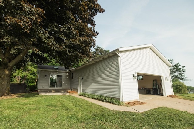 back of property with a yard and a garage