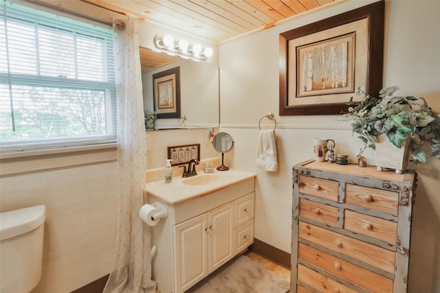 bathroom featuring vanity, toilet, crown molding, and wood ceiling