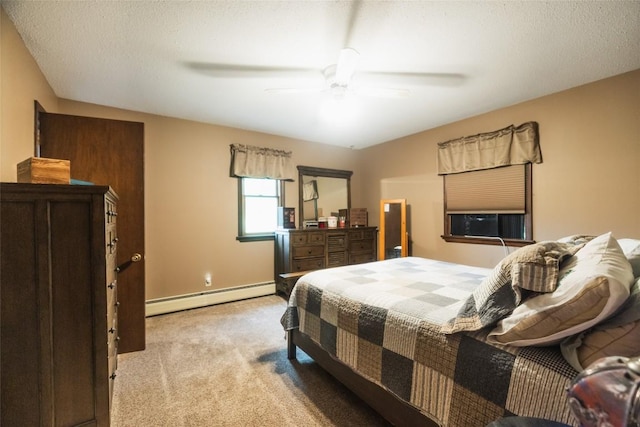 carpeted bedroom featuring ceiling fan, a textured ceiling, and a baseboard heating unit