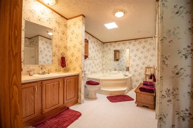 bathroom featuring a textured ceiling, a bathtub, crown molding, and vanity