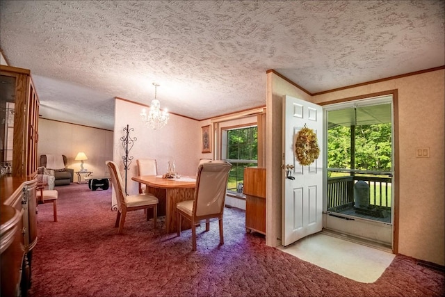 carpeted dining area with a chandelier, a textured ceiling, and ornamental molding