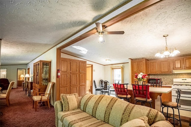 living room with carpet flooring, a textured ceiling, ceiling fan with notable chandelier, and vaulted ceiling