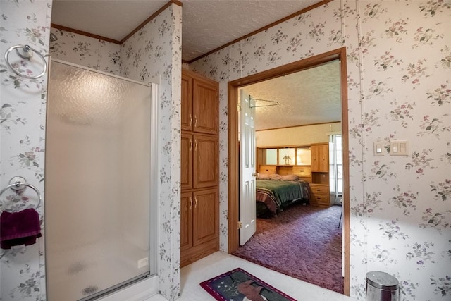 bathroom with ornamental molding, a textured ceiling, and walk in shower