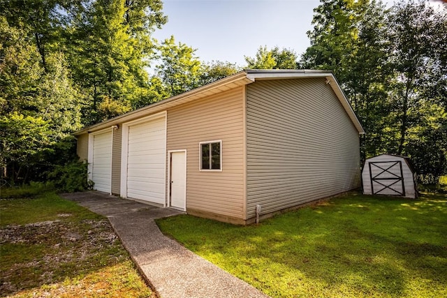 view of outbuilding with a garage and a yard