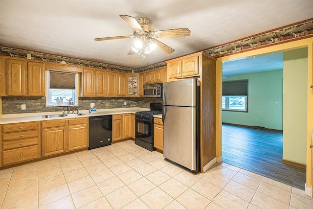4164 Emily Dr, North East, PA 16428 - kitchen featuring black appliances, ceiling fan, tasteful backsplash, light tile patterned floors, and glass insert cabinets