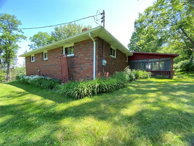 view of property exterior featuring a yard and a sunroom