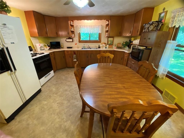 kitchen featuring ceiling fan, white appliances, and sink